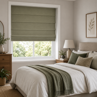 Cozy bedroom with a green Roman blind, white bedding, and wooden furniture.